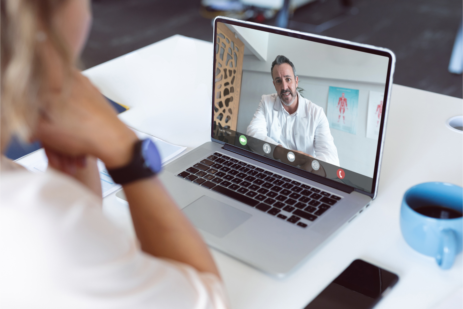 Person watching healthcare professional speaking during a webinar on a laptop